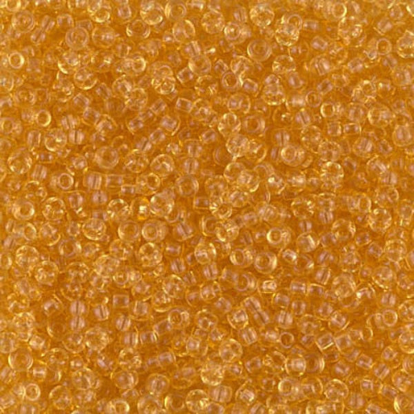 Close-up of small yellow gold beads on a gold background