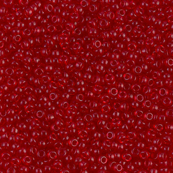 A close-up of numerous small, translucent red seed beads with a glossy finish.