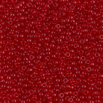 A close-up of numerous small, translucent red seed beads with a glossy finish.