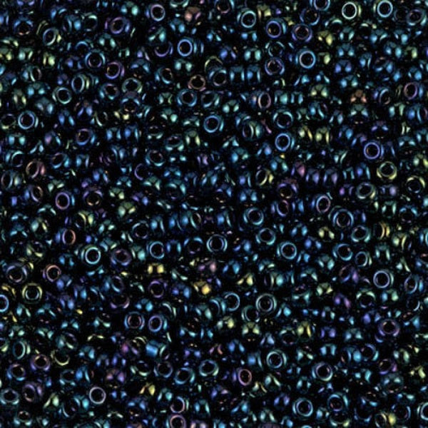Close-up of small metallic blue beads with a multicolor sheen.