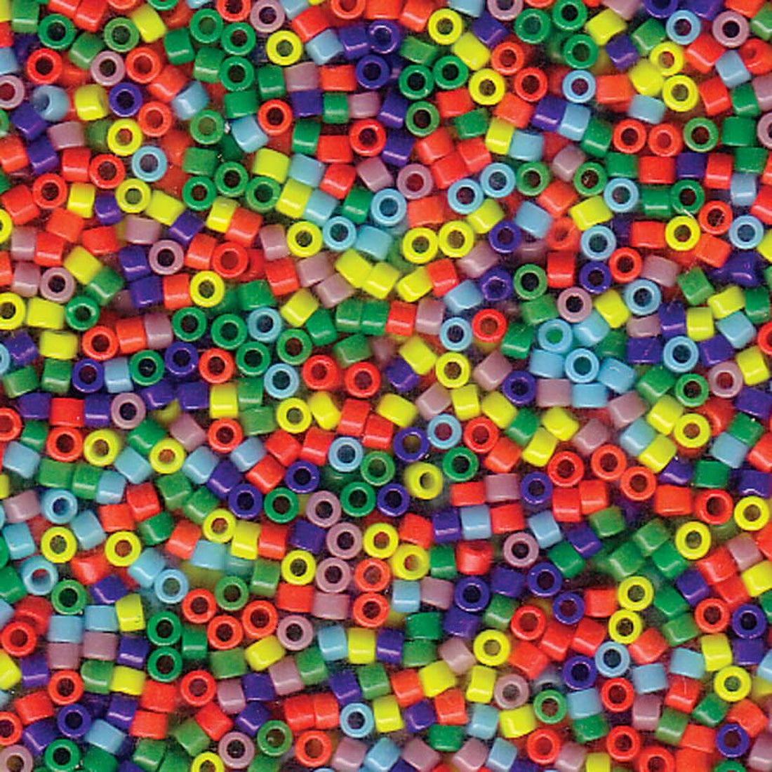 A dense, close-up pile of small cylindrical glass beads in a rainbow of colors including red, orange, yellow, green, blue, purple, and pink.