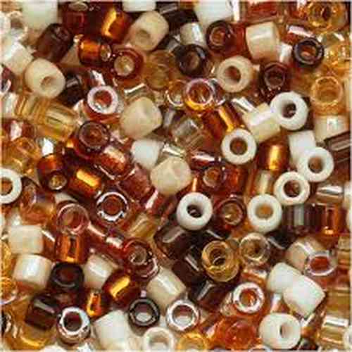 Close-up of 10/0 Delica seed beads in wheatberry mix, showing cylindrical glass beads in amber, rust, and honey tones for embroidery