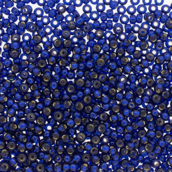 Close-up of blue glass beads with a metallic sheen